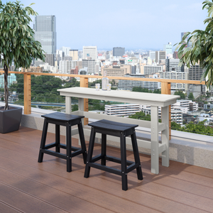 Outdoor setting with a white bar table and black stools on a wooden deck with cityscape in the background