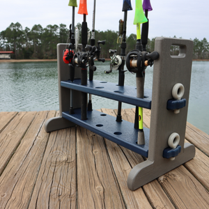 Fishing rod holder with multiple rods on a wooden dock by a body of water.