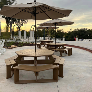 Brown picnic tables with a sunset background