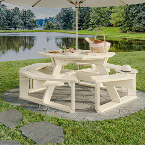 white picnic table with a pond in the background