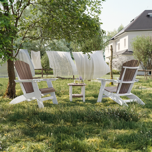 Two Adirondack chairs on a grassy area with clothes hanging on a line in the background.